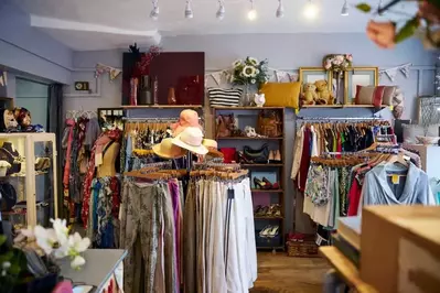 Interior of a thrift store with clothing and small furnature