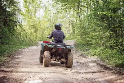 person riding an atv in the mountains