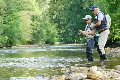 father and son trout fishing