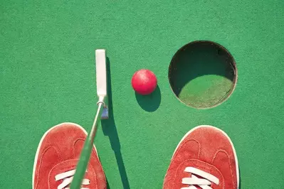 person playing mini golf